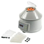 Centrifuge with orange-lidded rotor and a set of plastic pipette tips and tubes laid out beside it намерено.